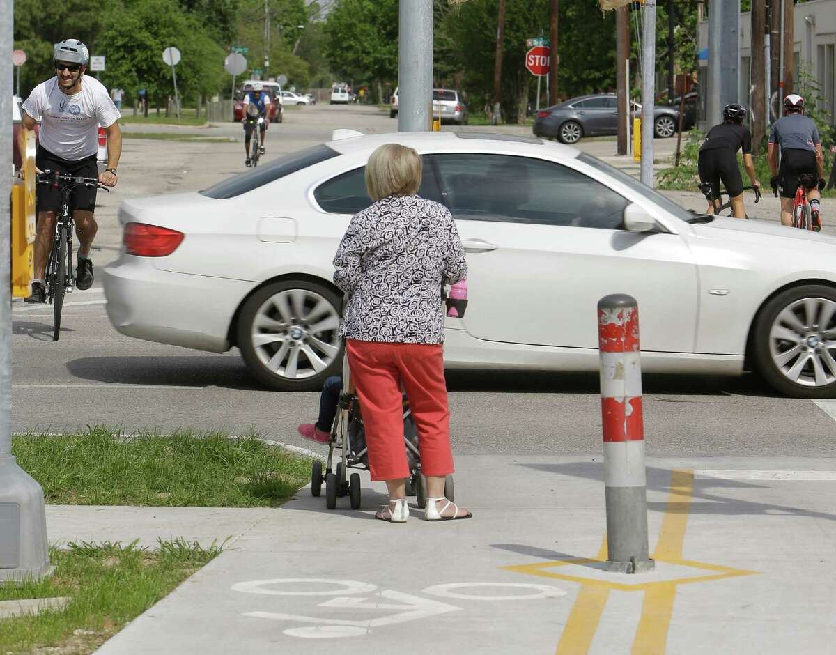 People are shown at the intersection of Yale and the Heights Hike and Bike Trail on April 6, at 7th. A new light will mean cyclists and joggers do not have to wait for a break in the traffic.