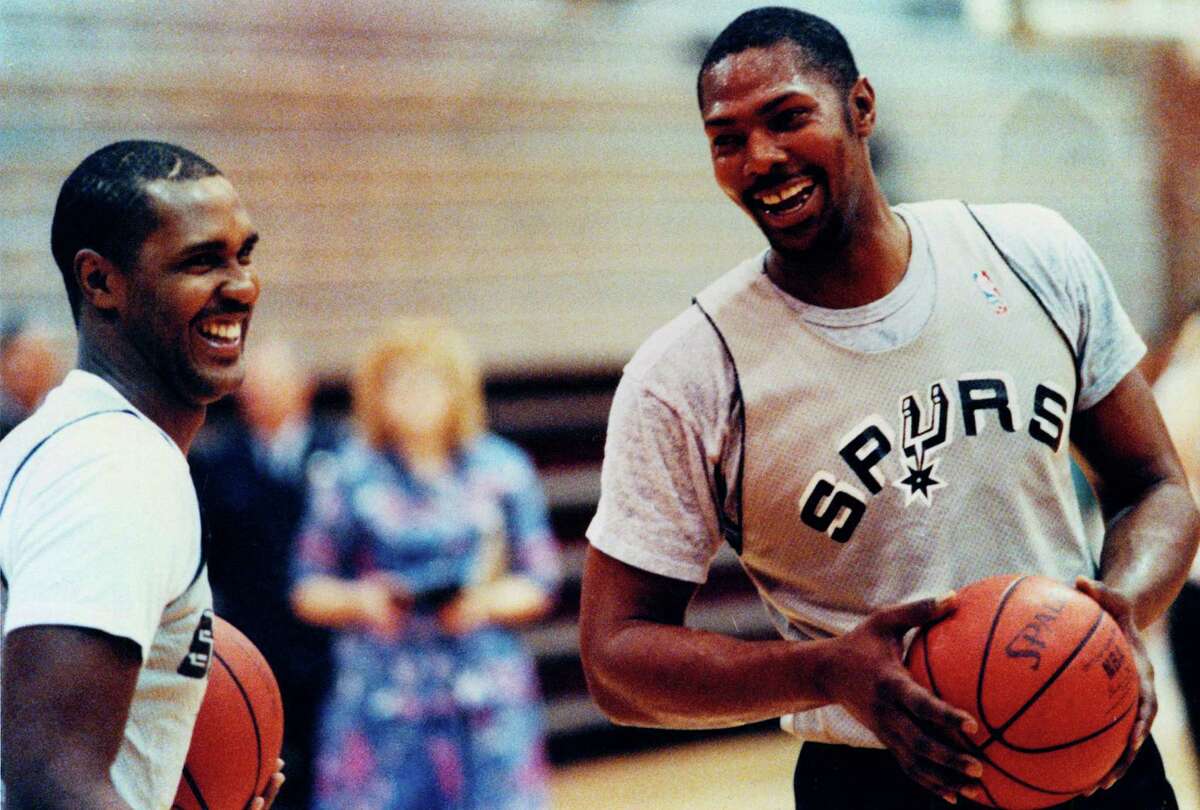 Mike Mitchell (right) shares a laugh with Spurs teammate Johnny Moore at practice on April 24, 1990.