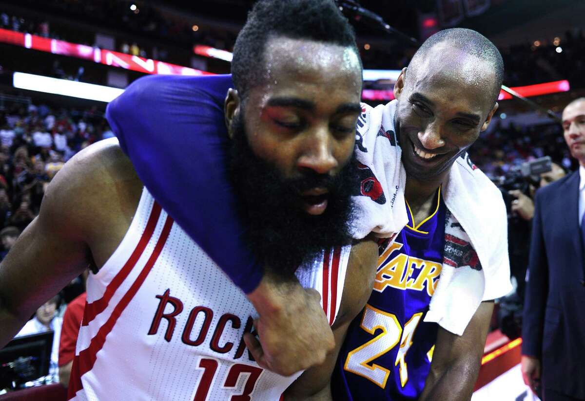 Los Angeles Lakers' Kobe Bryant has a little fun with Houston Rockets' James Harden after the game in Houston on Sunday, April 10, 2016.