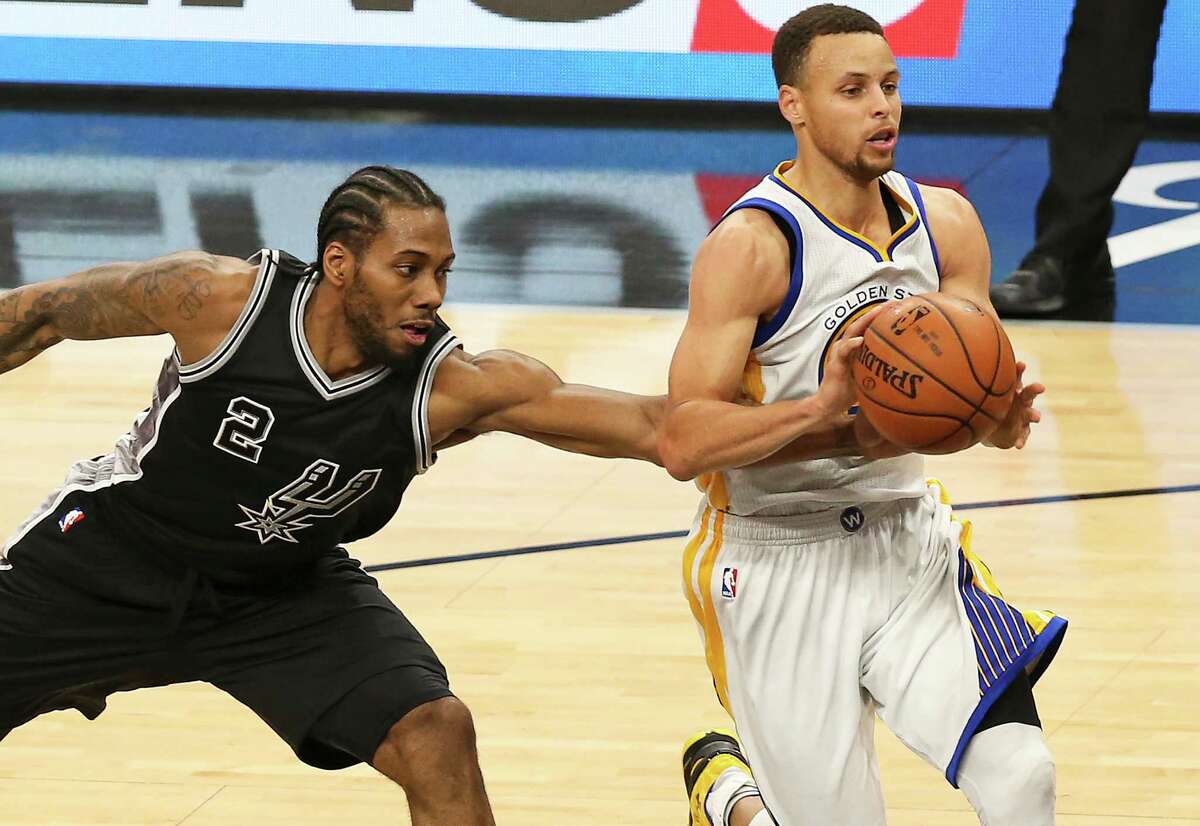 Kawhi Leonard tries to make a steal on Stephen Curry as the Spurs host Golden State at the AT&T Center on April 10, 2016.