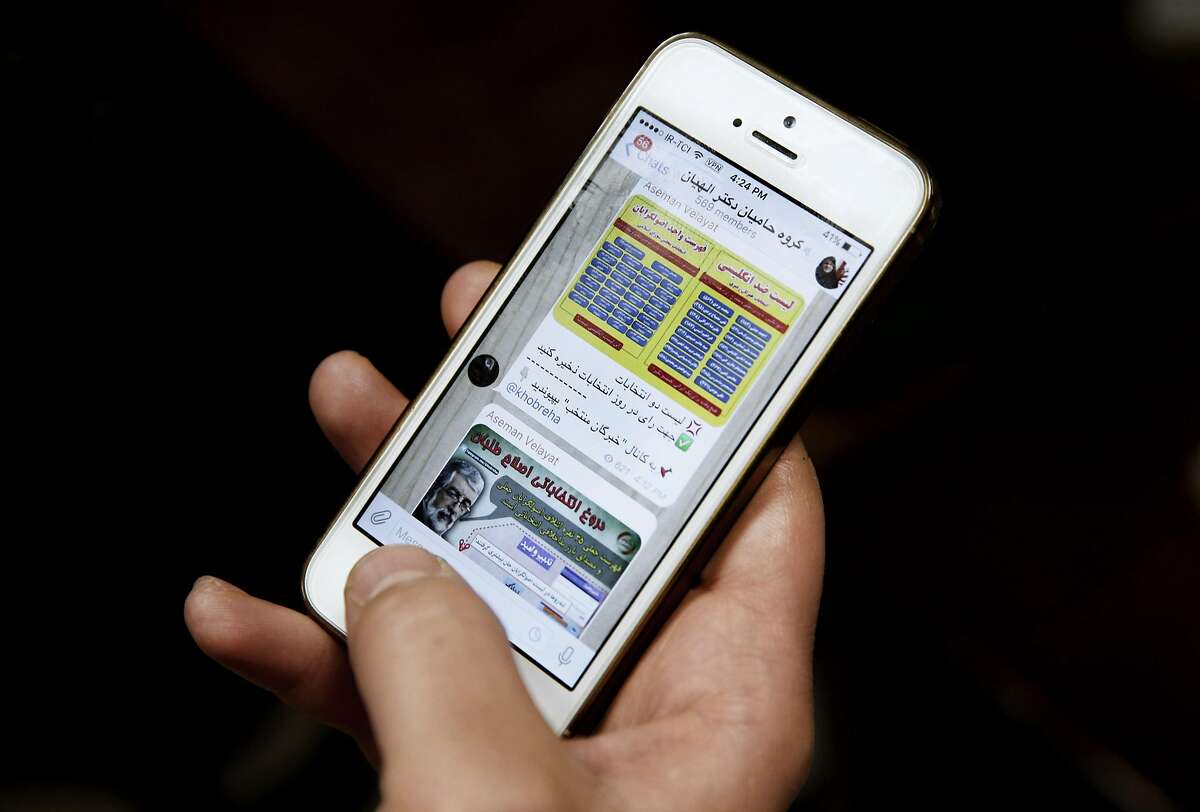 An Iranian man shows Telegram app messages from supporters of female conservative candidate Zohreh Elahian, on his mobile phone in Tehran, Iran, Wednesday, Feb. 24, 2016. Using messaging apps like Telegram and other social media platforms, Iranians and political aspirants of all kinds are preparing for Friday�s vote for parliament and the Assembly of Experts, trading lists of names for those backing their views. (AP Photo/Vahid Salemi)