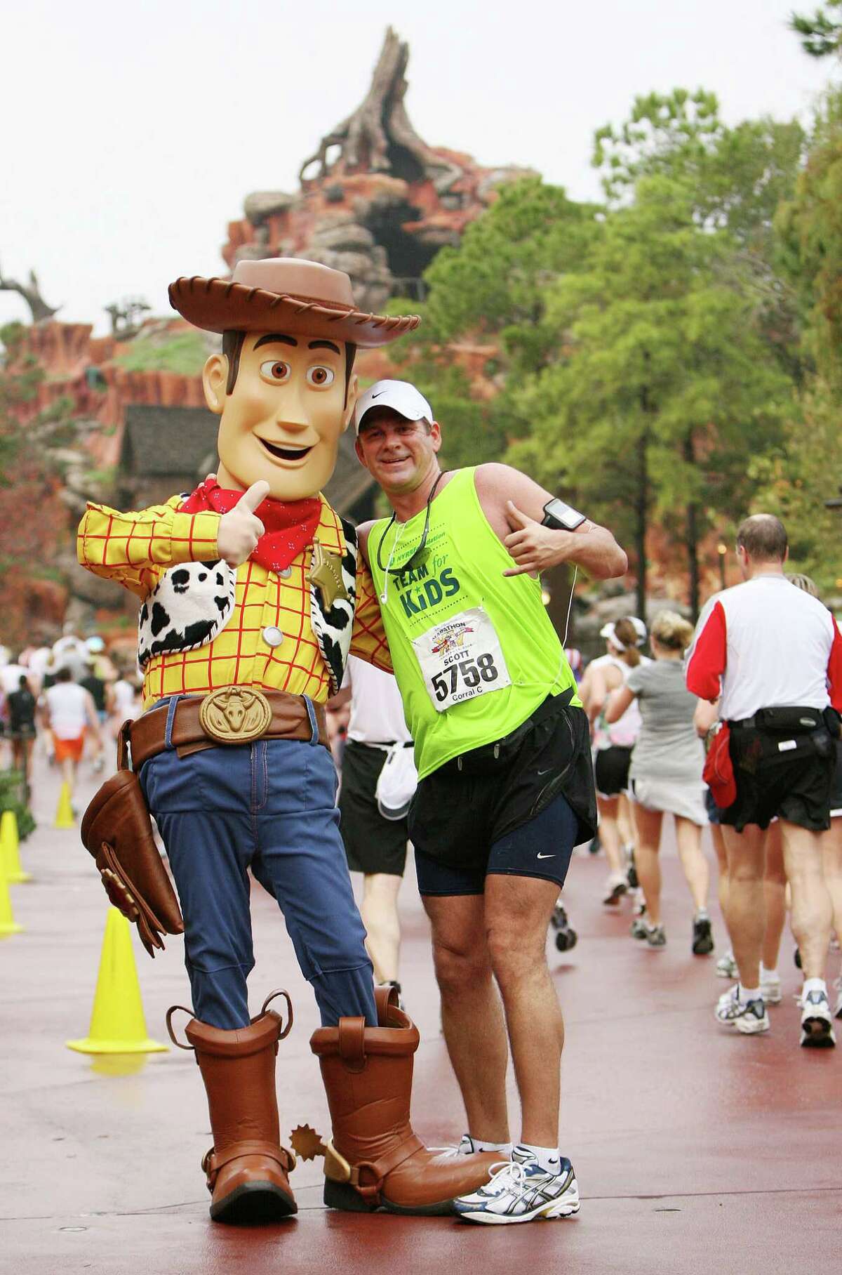 Athletes pose with characters (Woody from "Toy Story") and run through Frontierland in the Magic Kingdom in Lake Buena Vista, Fla. Jan.13, 2008, in the 15th Annual Walt Disney World Marathon. More than 18,000 registered for the race, an event record.
