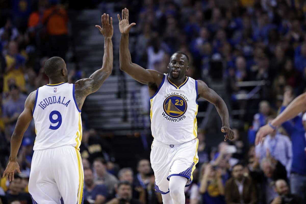 Golden State Warriors' Draymond Green (23) celebrates with Andre Iguodala (9) during the second half of an NBA basketball game against the San Antonio Spurs Thursday, April 7, 2016, in Oakland, Calif. Golden State won 112-101. (AP Photo/Marcio Jose Sanchez)