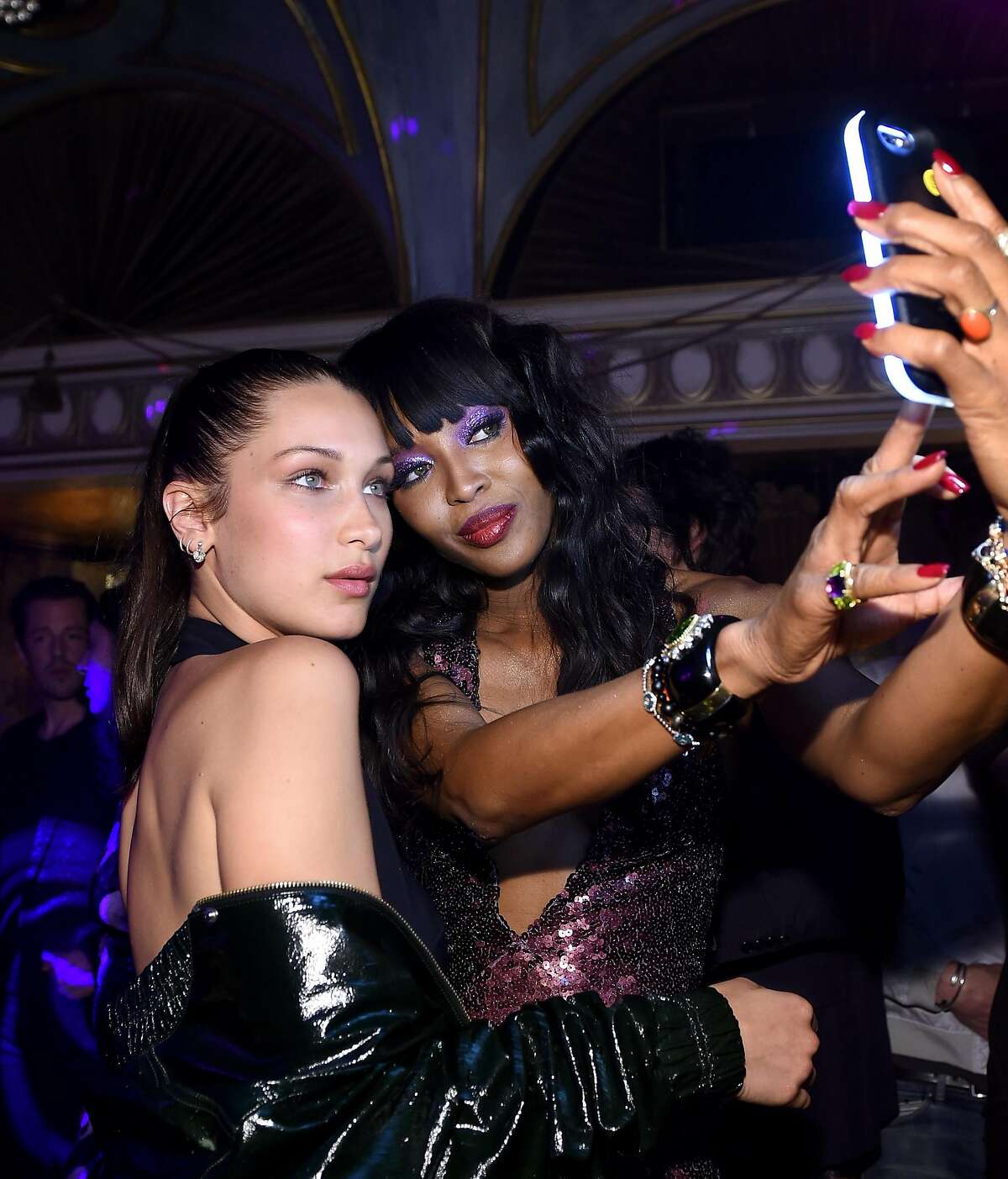NEW YORK, NEW YORK - APRIL 07: Bella Hadid (L) and Naomi Campbell take a selfie as Marc Jacobs & Benedikt Taschen celebrate NAOMI at The Diamond Horseshoe on April 7, 2016 in New York City. (Photo by Dimitrios Kambouris/Getty Images for Marc Jacobs International, LLC)
