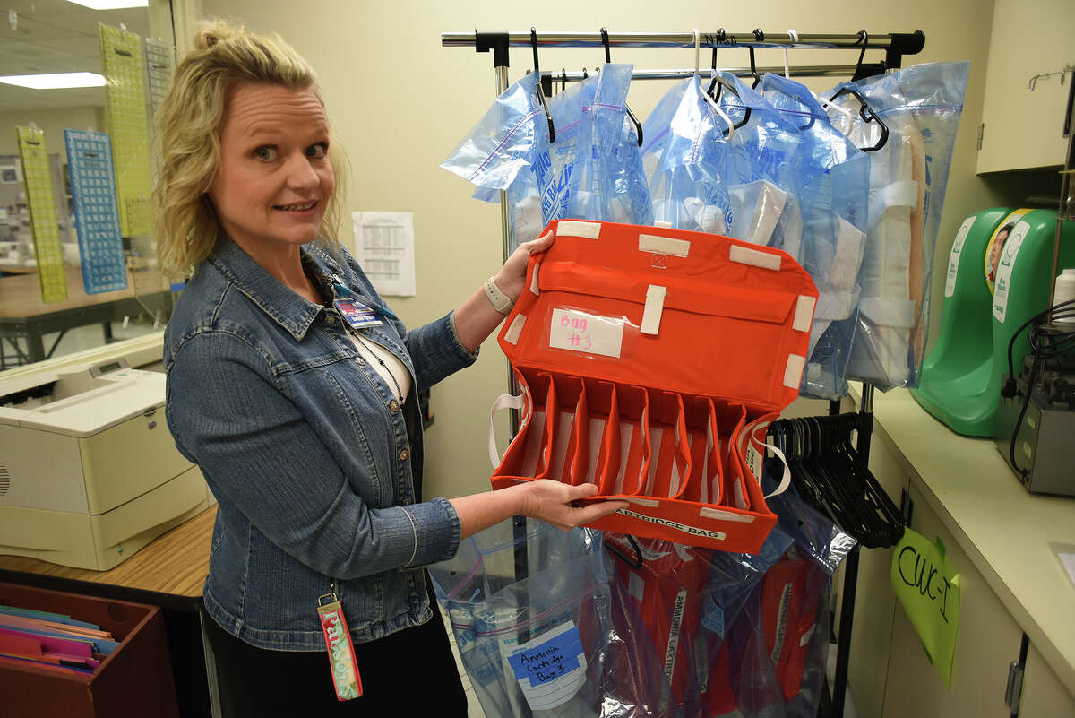 Oak Ridge High School fashion design teacher Darlene Parsons shows off one of the astronaut ammonia cartridge bags made by her NASA Hunch team members earlier in the Spring. (Photo by Jerry Baker/Freelance)