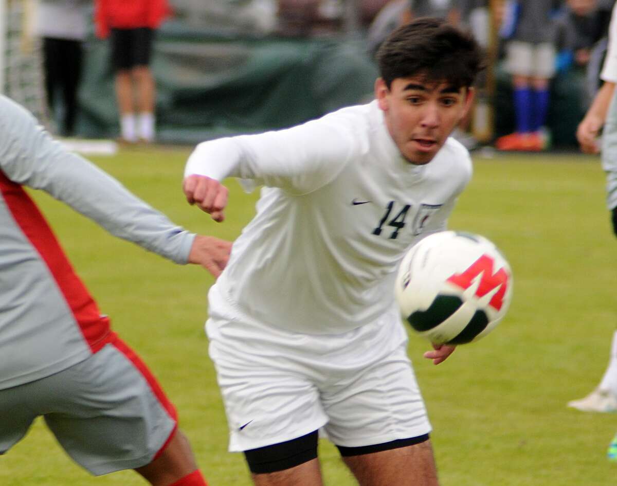 The Woodlands' Rafael Ortiz clears the ball during the Cy Lakes and The Woodlands High Scholl soccer game. Photograph by David Hopper