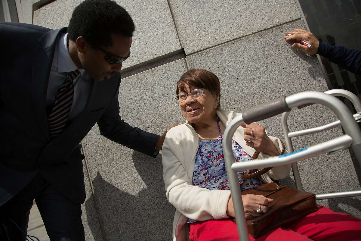 Iris Canada, right, is cheered on by her supporters during a news conference on Tuesday, April 12, 2016 in San Francisco, Calif. Supporters of Canada, a 99-year-old woman who faces eviction from her Western Addition apartment, rallied and held a news conference outside the Superior Court of California. Canada has lived in her apartment for decades.