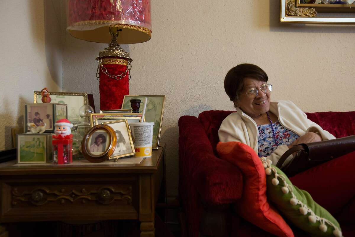 99-year-old Iris Canada laughs as she sees herself on television, Tuesday, April 12, 2016 in San Francisco, Calif. Canada faces eviction from her Western Addition apartment, where she has lived since the 1940s.