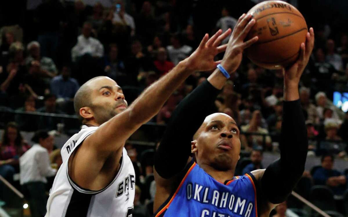 Spurs’ Tony Parker attempts to block a layup by Oklahoma City Thunder’s Randy Foye at the AT&T Center on April 12, 2016.