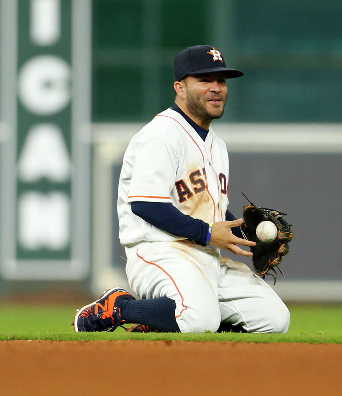 Astros second baseman Jose Altuve goes from a scare to a smile after avoiding a collision with shortstop Carlos Correa while fielding a grounder up the middle.