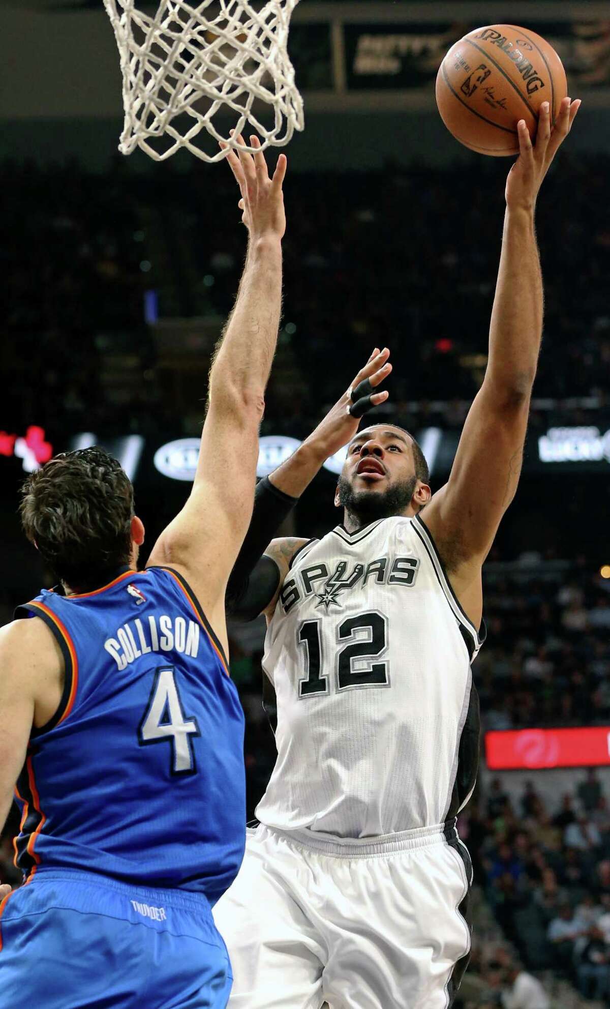 LaMarcus Aldridge shoots over Nick Collison as the Spurs host Oklahoma at the AT&T Center on April 12, 2016.