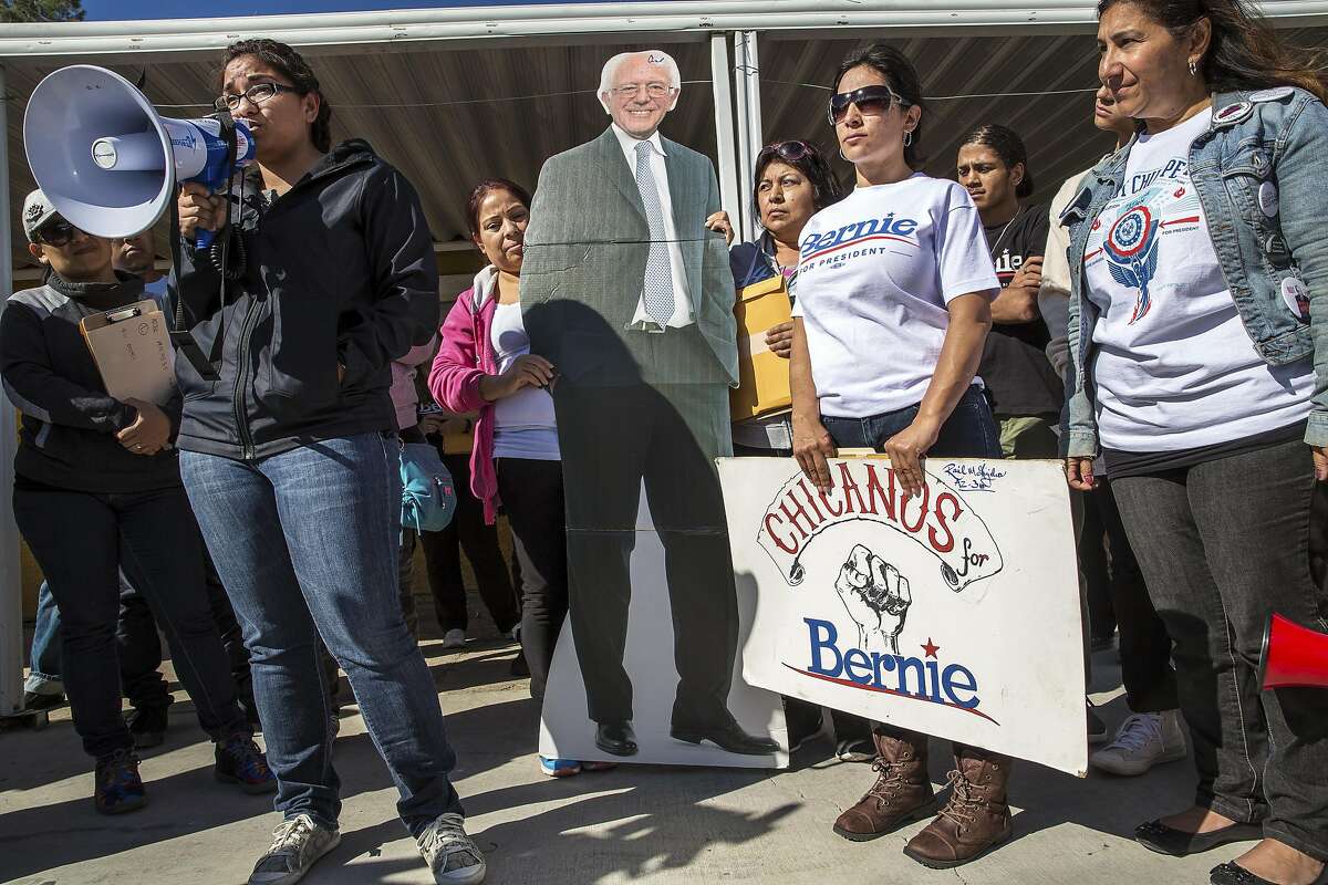 Maria Castro, left, speaks as campaign workers and supporters gather at Sen. Bernie Sanders' northeast campaign office for a rally and canvassing in Las Vegas, Feb. 18, 2016. (Monica Almeida/The New York Times)