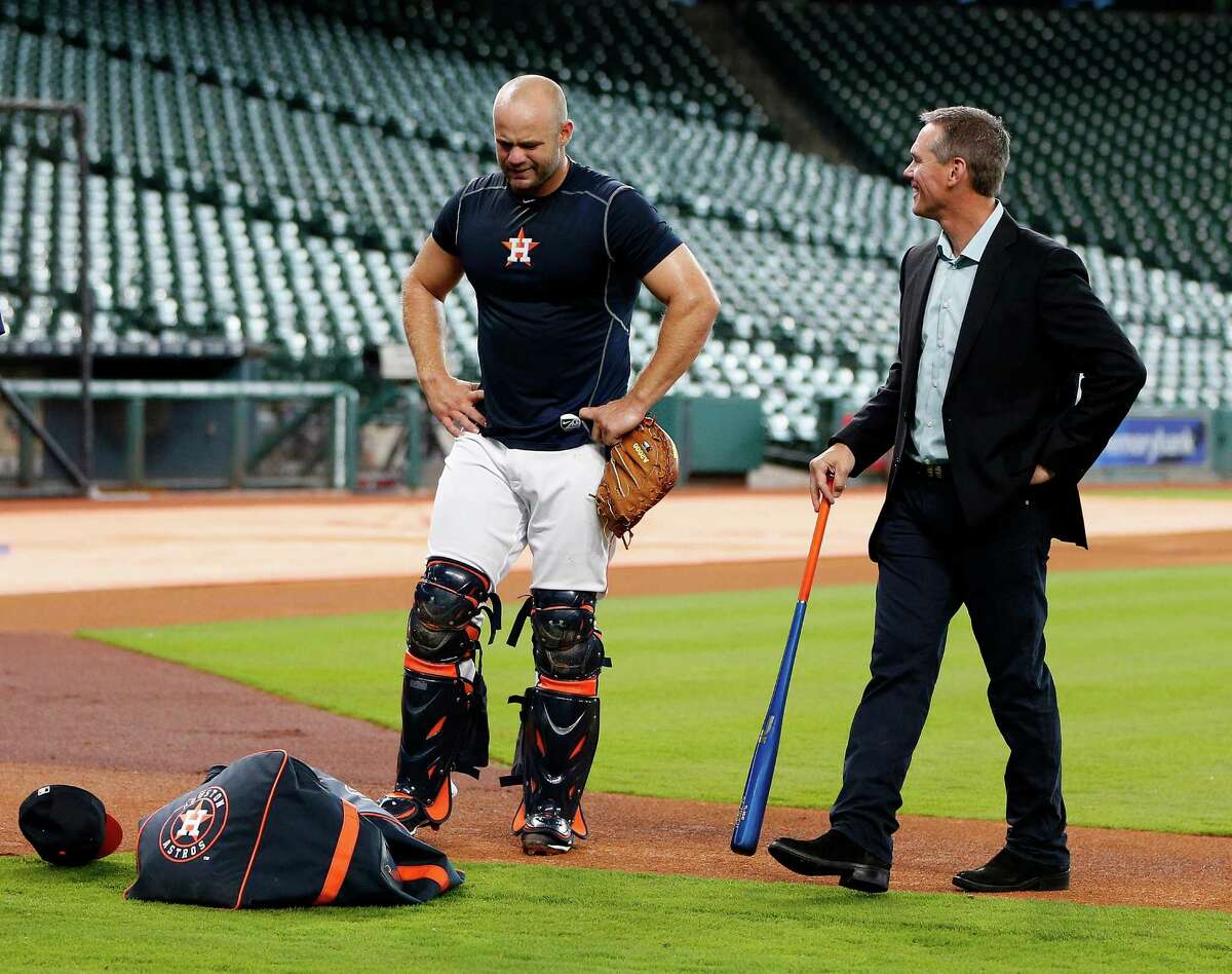 Houston Astros Evan Gattis talks with Craig Biggio after working out at catcher during an early batting practice before the start of an MLB game at Minute Maid Park.