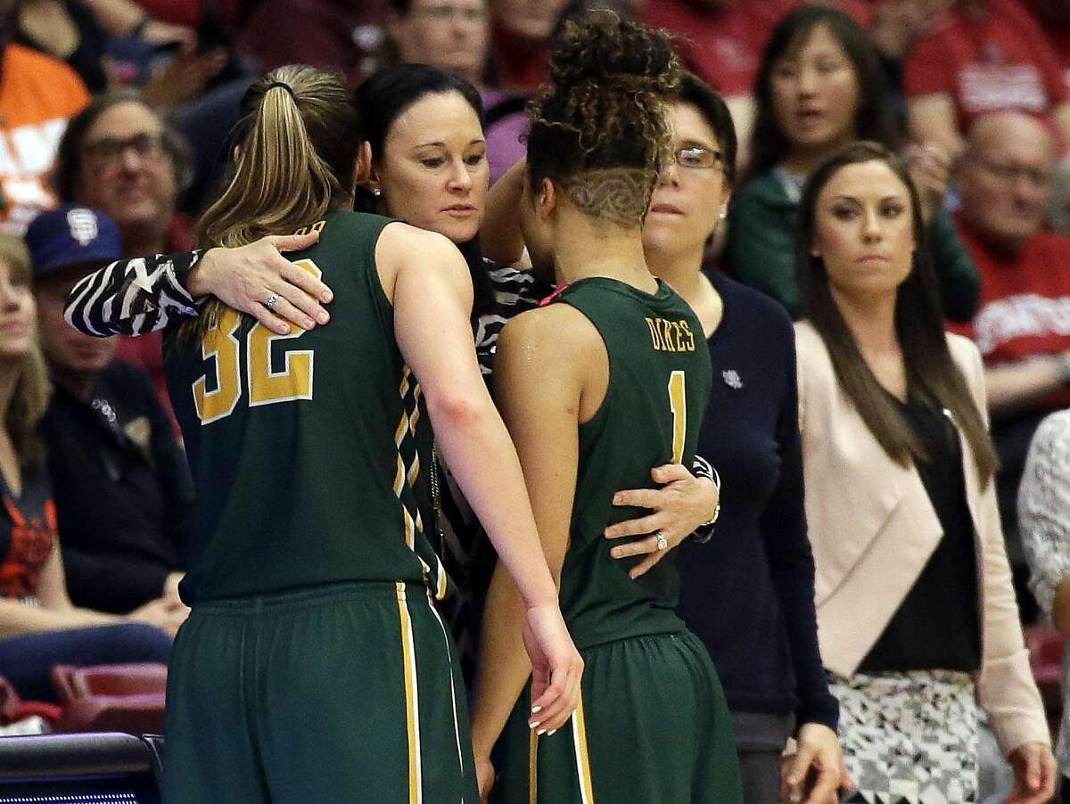 San Francisco head coach Jennifer Azzi, center, hugs forward Taylor Proctor (32) and guard Zhane Dikes (1) in the closing seconds of 85-58 loss to Stanford in a first-round women's college basketball game in the NCAA Tournament Saturday, March 19, 2016, in Stanford, Calif. (AP Photo/Marcio Jose Sanchez)