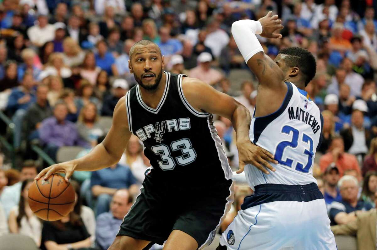 San Antonio Spurs' Boris Diaw (33) of France moves to the basket for a shot against Dallas Mavericks' Wesley Matthews (23) in the second half of an NBA basketball game, Wednesday, April 13, 2016, in Dallas. The Spurs won 96-91. (AP Photo/Tony Gutierrez)