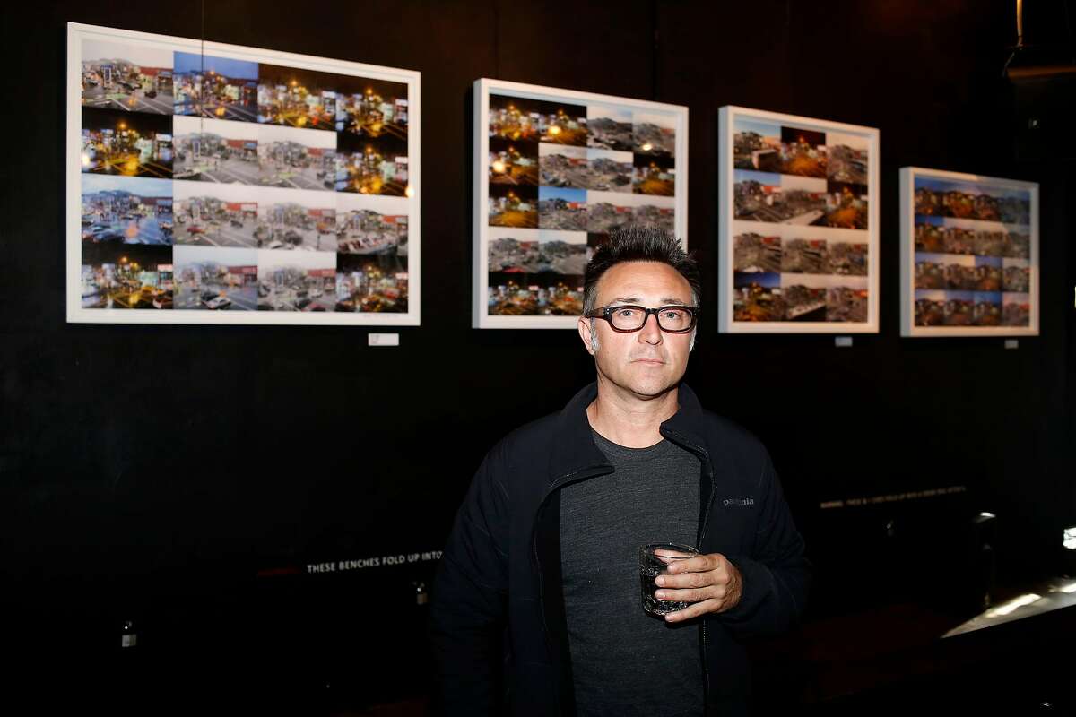 Artist and bar owner Michael Krouse stands in front of a few of the framed photographic collages from his Arco Project hanging on the walls of the Madrone Art Bar in San Francisco, California, on Wednesday, April 13, 2016.