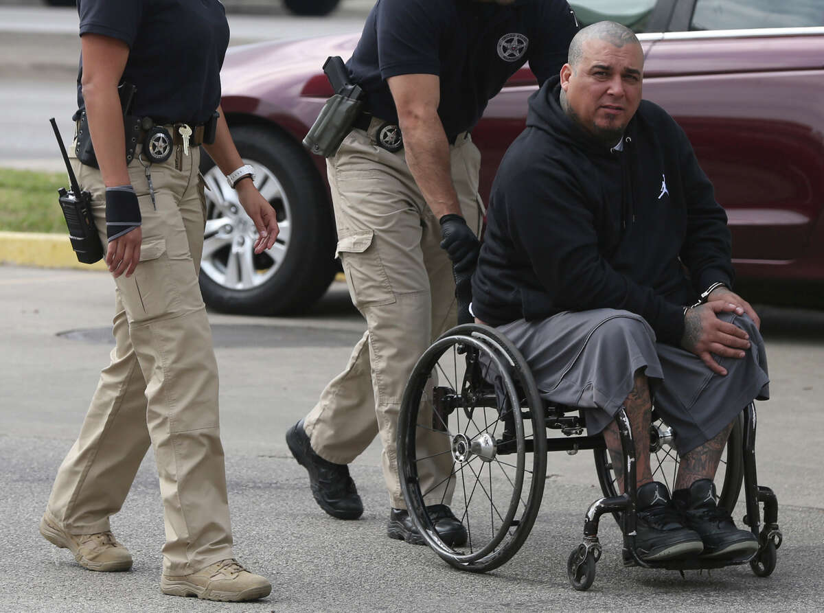 Joey Mertz Gozales, aka "wheelchair" is rolled Friday April 15, 2016 into the John H. Wood, Jr. U.S. Courthouse after numerous arrests were targeting the Mexican Mafia. The alleged suspects are facing federal drug charges.