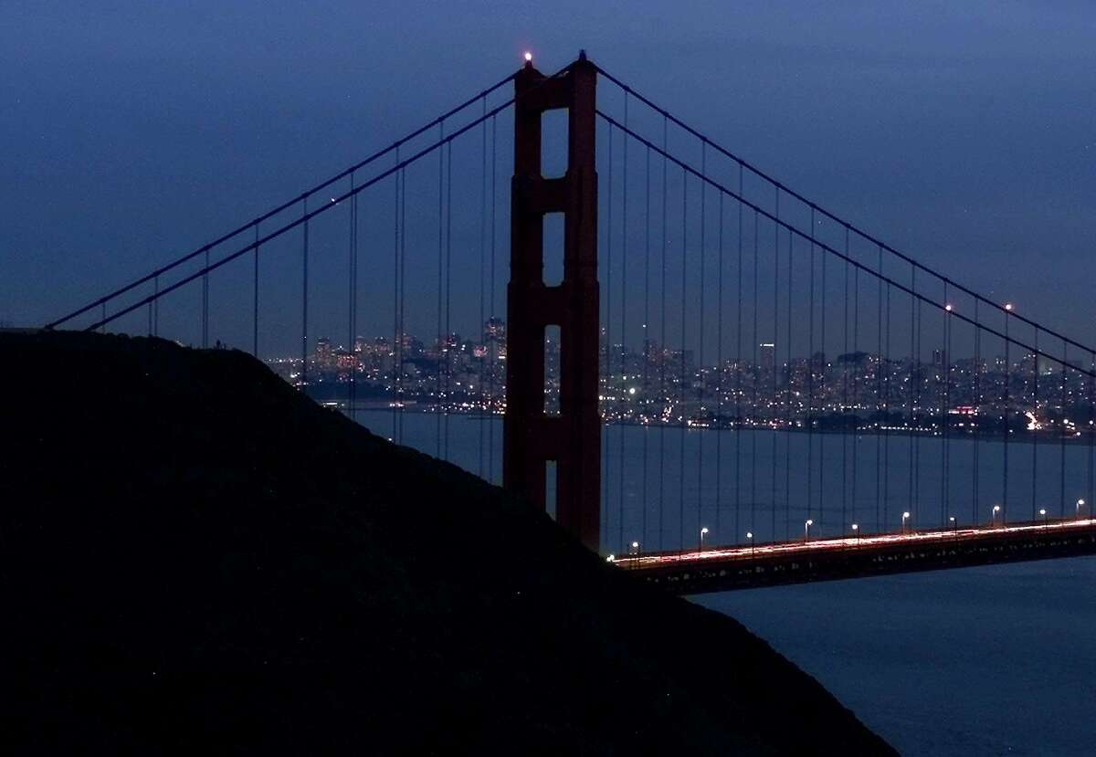 The north tower of the Golden Gate Bridge, which is normally illuminated, remains darkened in Sausalito, Calif., Thursday, Jan. 18, 2001, as California continues its energy shortages. Earlier in the day rolling blackouts were experienced for the second straight day in Northern California. (AP Photo/Eric Risberg). HOUCHRON CAPTION (01/21/2001): The north tower of the Golden Gate Bridge, which is normally illuminated, was darkened Thursday as California experiences rolling blackouts due to the energy crisis. Concern is building among estern states that California's problems may spread.