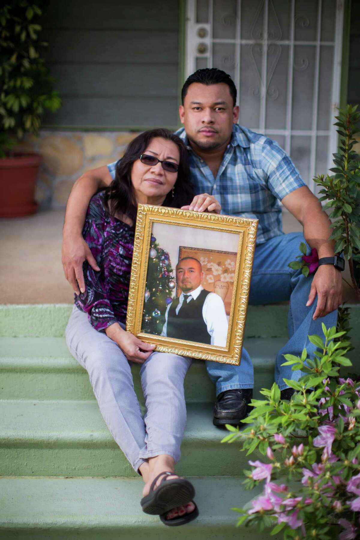Rolando Ventura with his mother, Cristina Martinez hold a portrait of Omar Ventura who was unarmed when he got shot by a off-duty Houston police officer five years ago. Friday, March 11, 2016, in Houston.