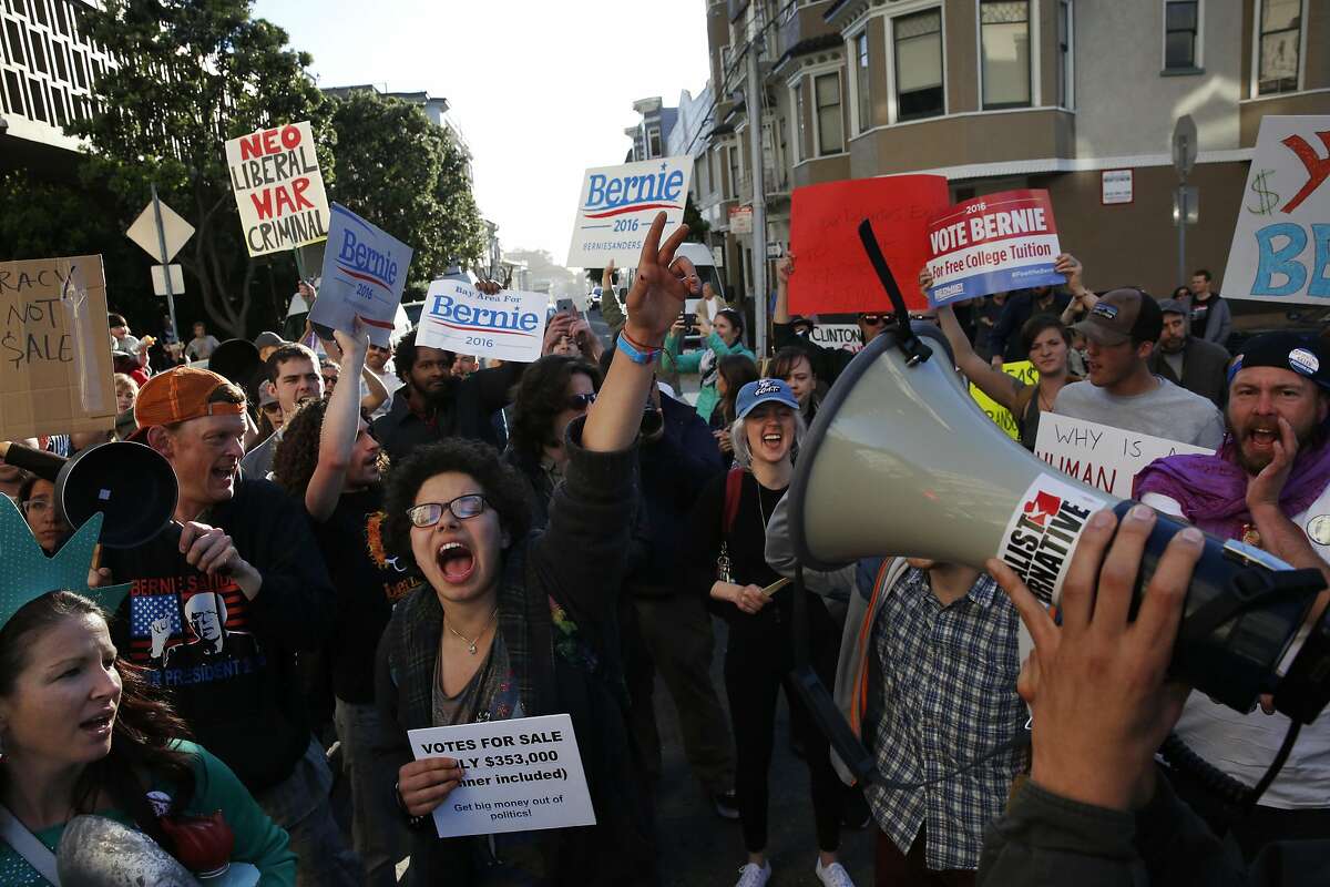 Ellie Koepplinger cheers with other Bernie Sanders supporters during a Hillary Clinton fundraising protest in Nob Hill April 15, 2016 in San Francisco, Calif. The fundraiser was attended by George Clooney, among others. Dozens of protesters showed up and marched around the block to each entrance where police had set up barricades.during a Hillary Clinton fundraising protest in Nob Hill April 15, 2016 in San Francisco, Calif. The fundraiser was attended by George Clooney, among others. Dozens of protesters showed up and marched around the block to each entrance where police had set up barricades.