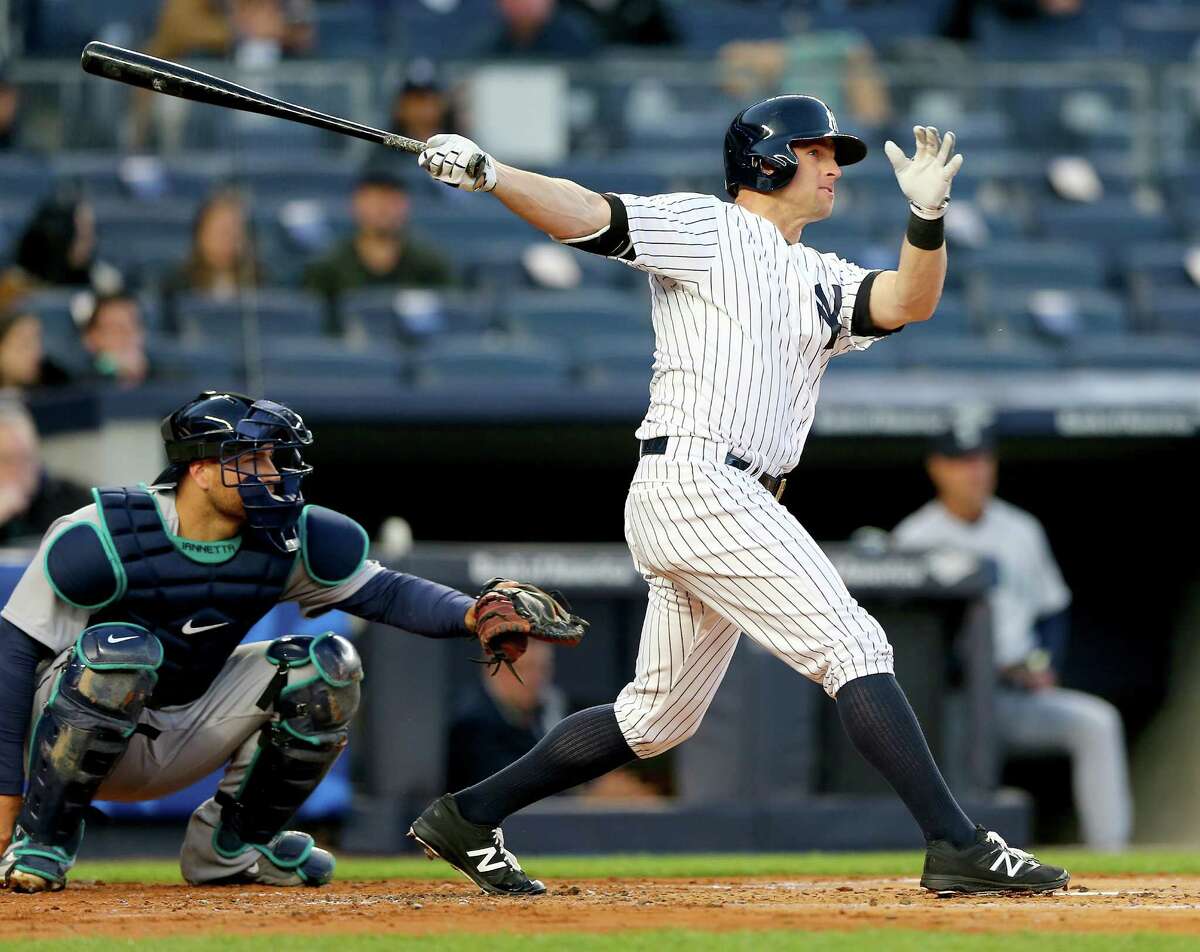 NEW YORK, NY - APRIL 15: Brett Gardner #11 of the New York Yankees hits a solo home run in the first inning as Chris Iannetta #33 of the Seattle Mariners defends at Yankee Stadium on April 15, 2016 in the Bronx borough of New York City. (Photo by Elsa/Getty Images) ORG XMIT: 607675719