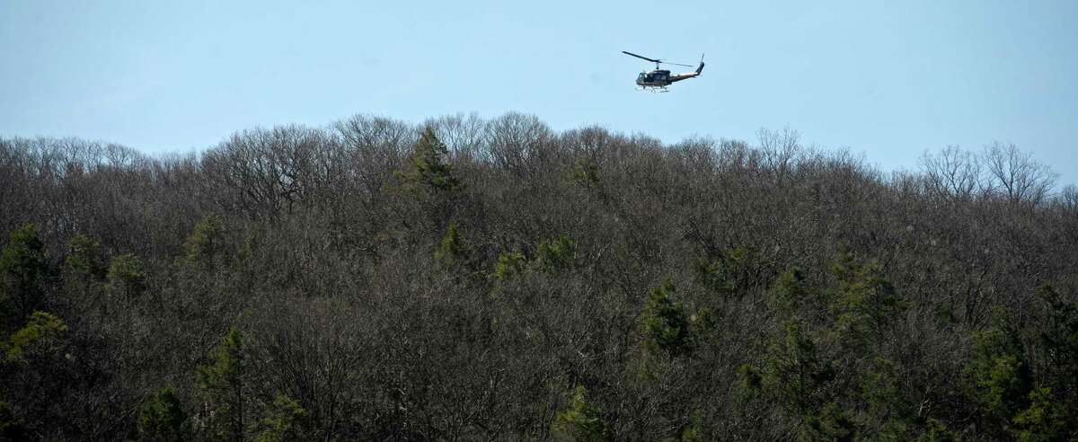 Eagle 1 search and rescue helicopter flies over Clatter Valley Park, in New Milford, during a search and rescue drill on Saturday, April 16, 2016, in New Milford, Conn.