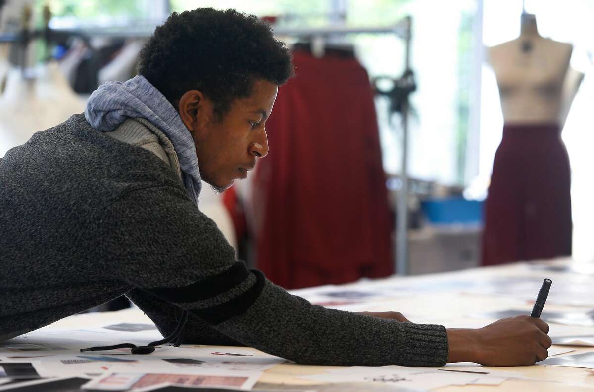 Fashion design student Elishes Cavness prepares a presentation for a fashion trends and forecasting class run by Mikel Rosen at the Art Institute of California in San Francisco, Calif. on Wednesday, April 13, 2016.