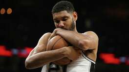 San Antonio Spurs' Tim Duncan hugs the ball at the start of the second half against the New Orleans Pelicans at the AT&T Center, Wednesday, March 30, 2016.
