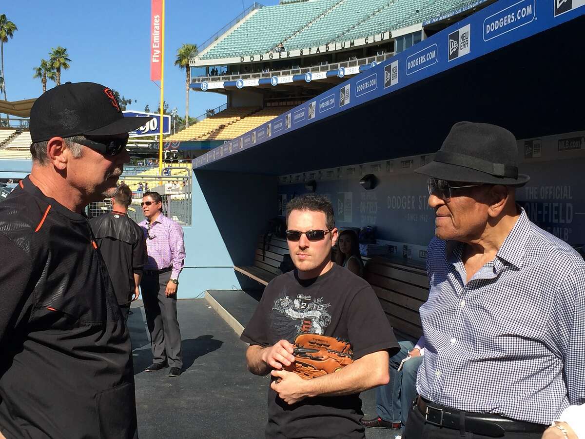 Giants manager Bruce Bochy, who turned 61 Saturday, chats with Don Newcombe, who debuted with the Dodgers in 1949, two years after Jackie Robinson. Newcombe was the first African American to pitch in a World Series game.