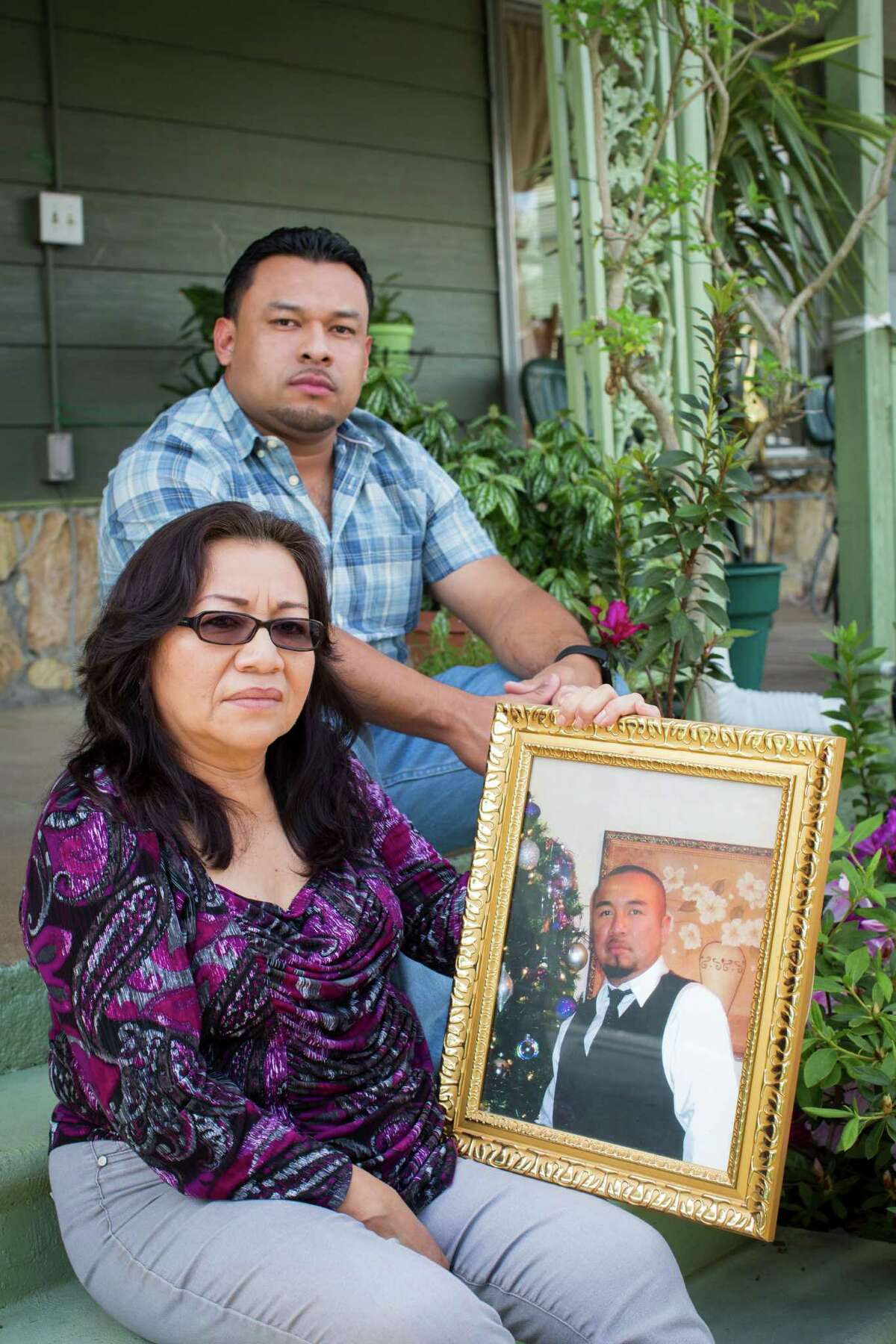 Rolando Ventura and his mother, Cristina Martinez, display a portrait of Rolando's brother Omar, who was unarmed when he was shot to death by an off-duty Houston police officer five years ago. The family believes the shooting was unjustified.