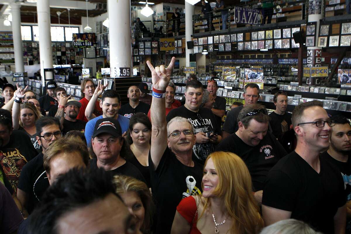 David Marrs, center, waits in the crowd before Metallica's live performance at Rasputin Records in Berkeley, Calif., on Saturday April 16, 2016