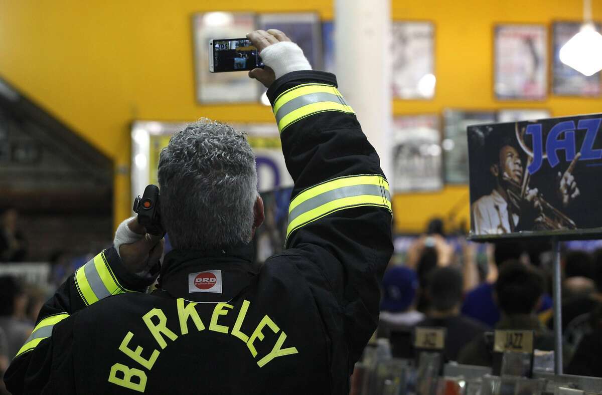 Even the local fire fighters working at the event got in to the spirit during Metallica's live performance at Rasputin Records in Berkeley, Calif., on Saturday April 16, 2016