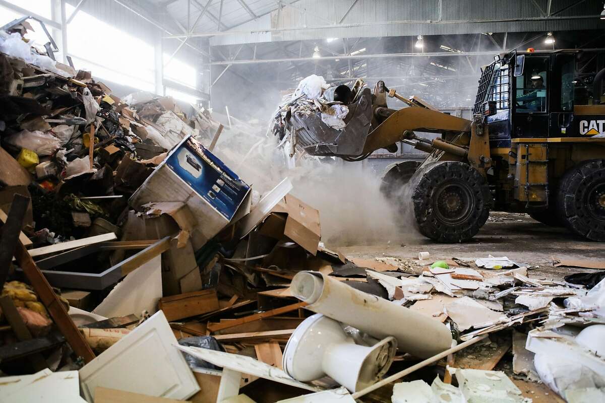 A loader picks up garbage to be sorted at the Recology Center in San Francisco , California, on Wednesday, April 14, 2016.