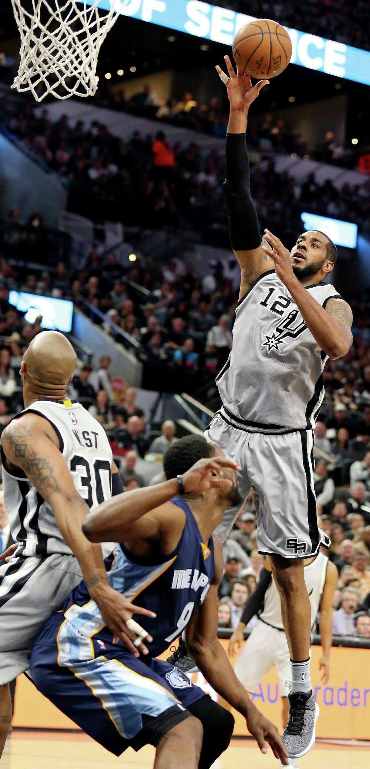 San Antonio Spurs' LaMarcus Aldridge shoots as San Antonio Spurs' David West and Memphis Grizzlies' Tony Allen look on during first half action of Game 1 in the first round of the Western Conference playoffs Sunday April 17, 2016 at the AT&T Center.