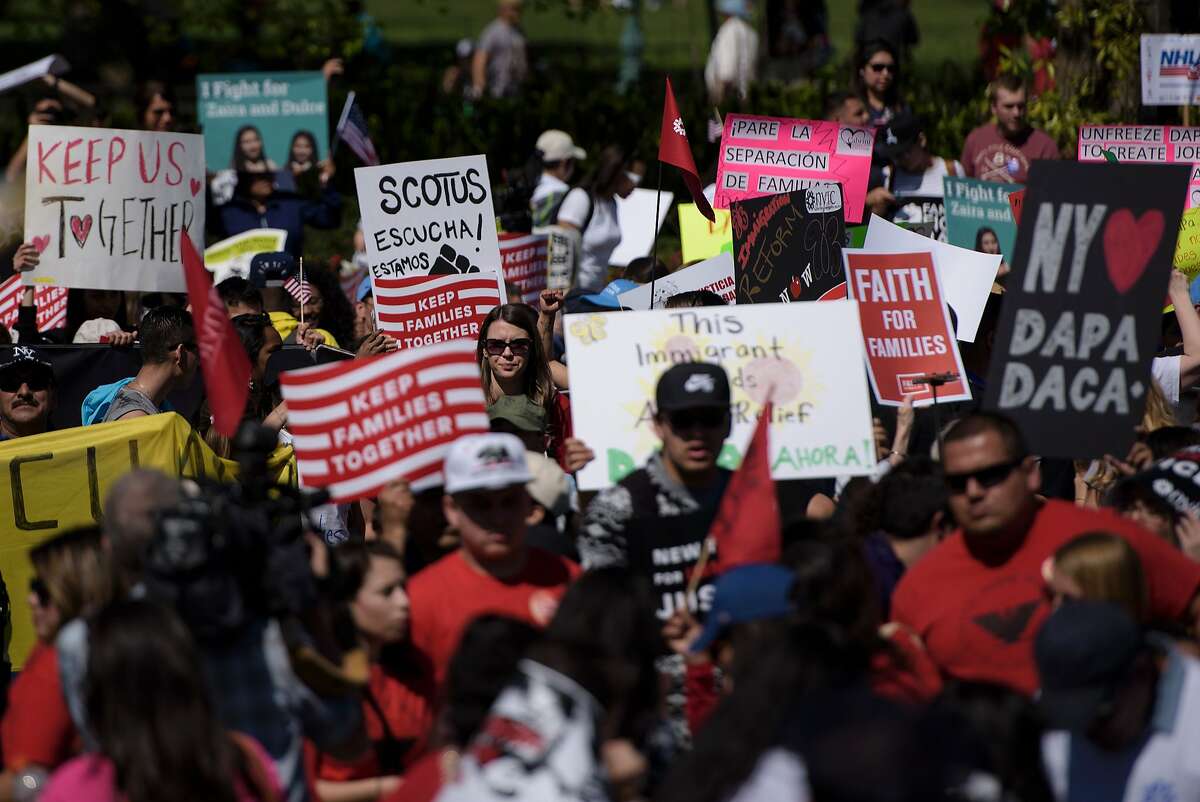 Supporters of immigration reform rally outside the US Supreme Court during arguments in United States vs Texas April 18, 2016 in Washington, DC. Hundreds of protesters rallied Monday outside the US Supreme Court as it weighed a major immigration case that could impact the fate of millions of people facing possible deportation and further raise the stakes in the 2016 White House race. 