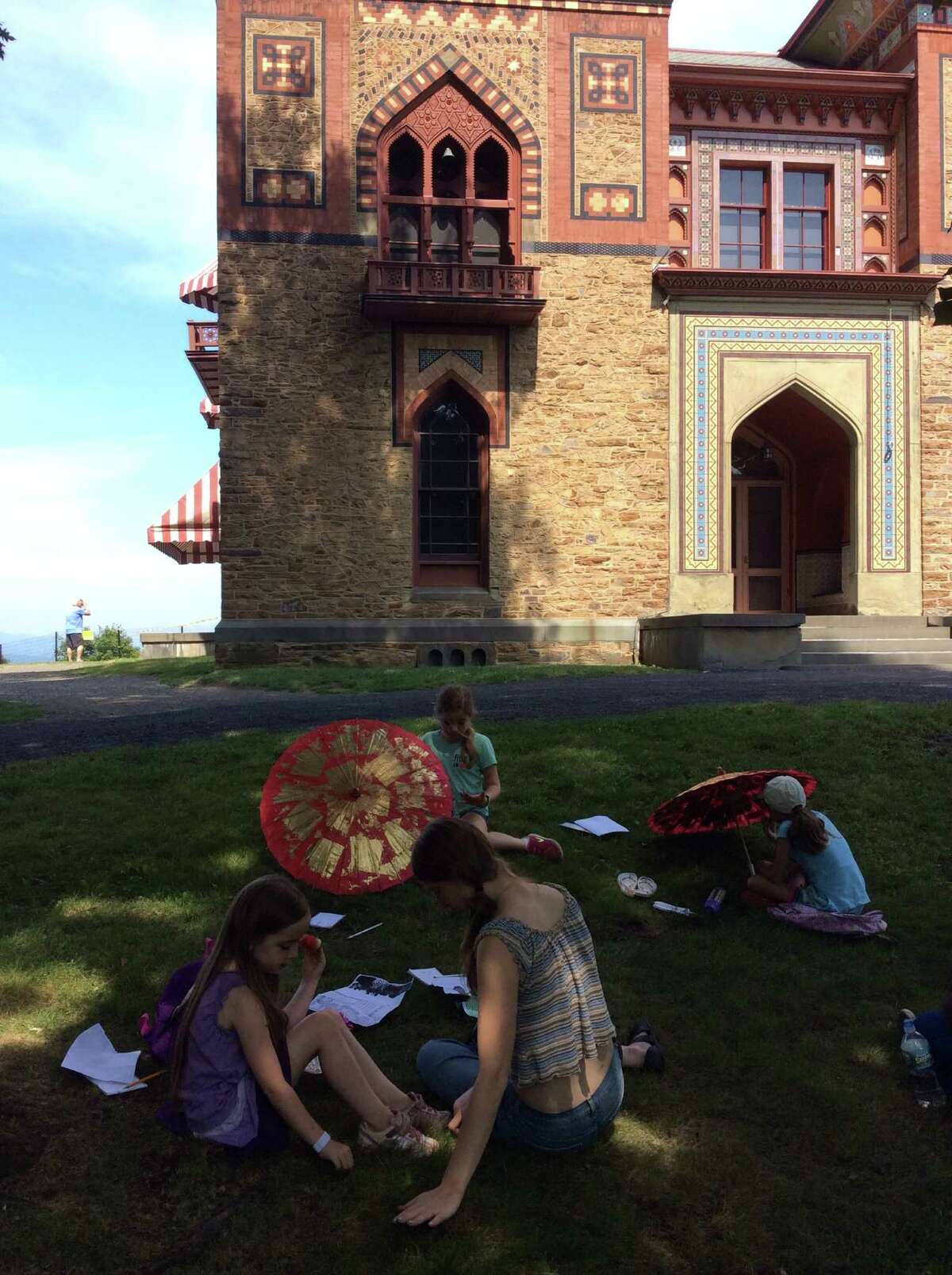 Students relax on the grass during a field trip to Olana in Hudson. (The Olana Partnership)