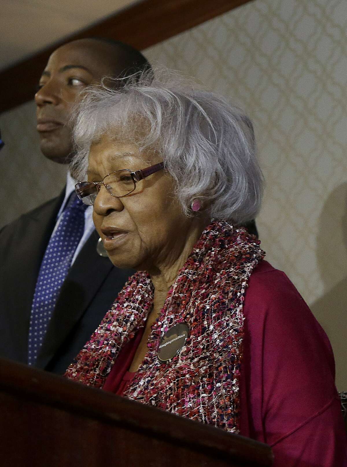 Katherine Neal, one of the plaintiffs filing a lawsuit over their ejection from a Napa Valley Wine Train, speaks in front of attorney Waukeen Q. McCoy during a news conference, Thursday, Oct. 1, 2015, in San Francisco. The group of mostly black women, members of a book club, settled their lawsuit in April 2016 for an undisclosed amount.