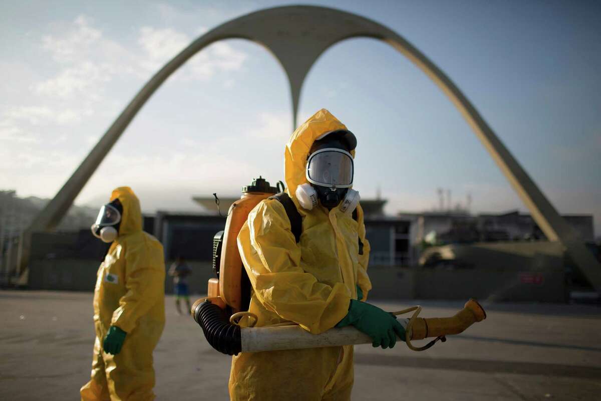 FILE - In this Tuesday, Jan. 26, 2016 file photo, a health workers stands in the Sambadrome spraying insecticide to combat the Aedes aegypti mosquito that transmits the Zika virus in Rio de Janeiro, Brazil. In the 1940s and 1950s, Brazilian authorities made such a ferocious assault on Aedes aegypti that the mosquito, that it was eradicated from Latin America's largest country by 1958. But eradication experts say there is little chance that Brazil can come anywhere near stamping out the pest like it did a half century ago.