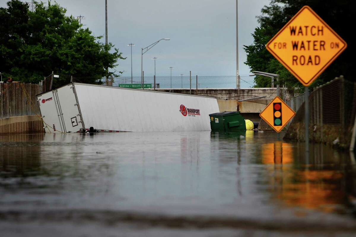 A truck is still partially submerged along the Beltway 8 feeder road near Hardy Road, Monday, April 18, 2016, in Houston.