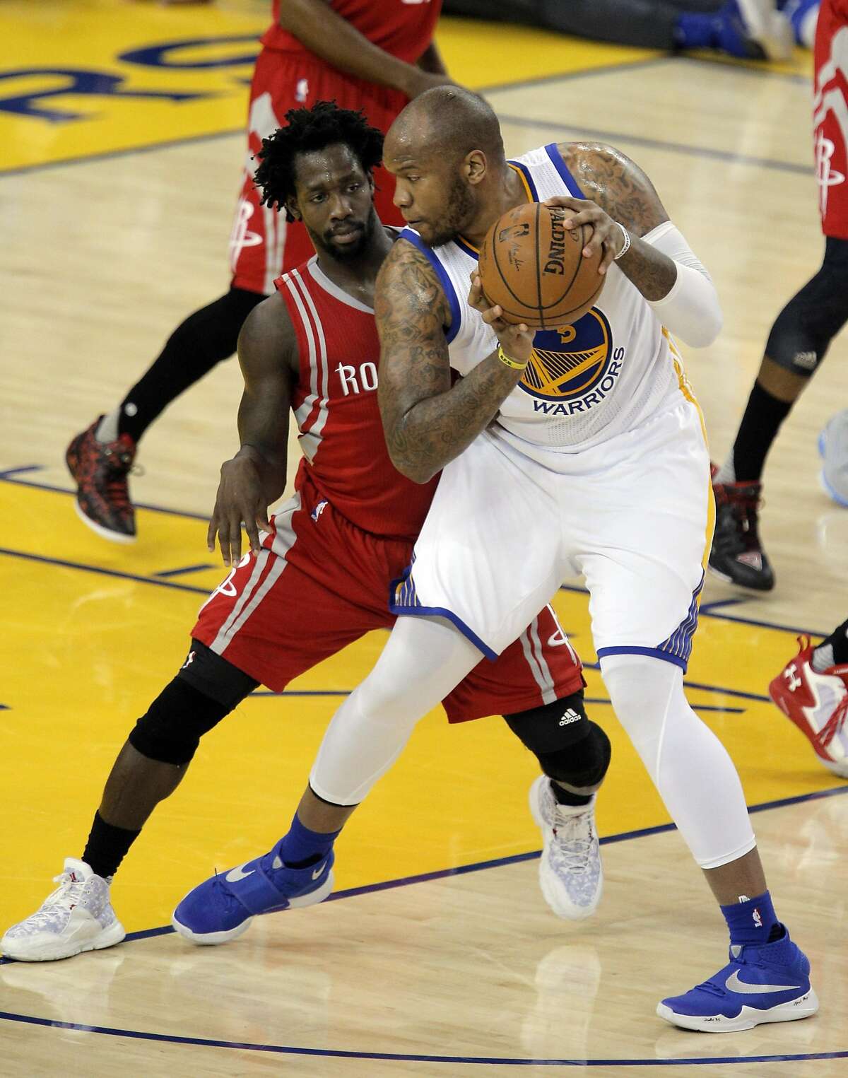 Patrick Beverley (2) defends against Marreese Speights (5) in the first half as the Golden State Warriors played the Houston Rockets in game 2 of the first round of the Western Conference Playoffs at Oracle Arena in Oakland, Calif., on Monday, April 18, 2016.