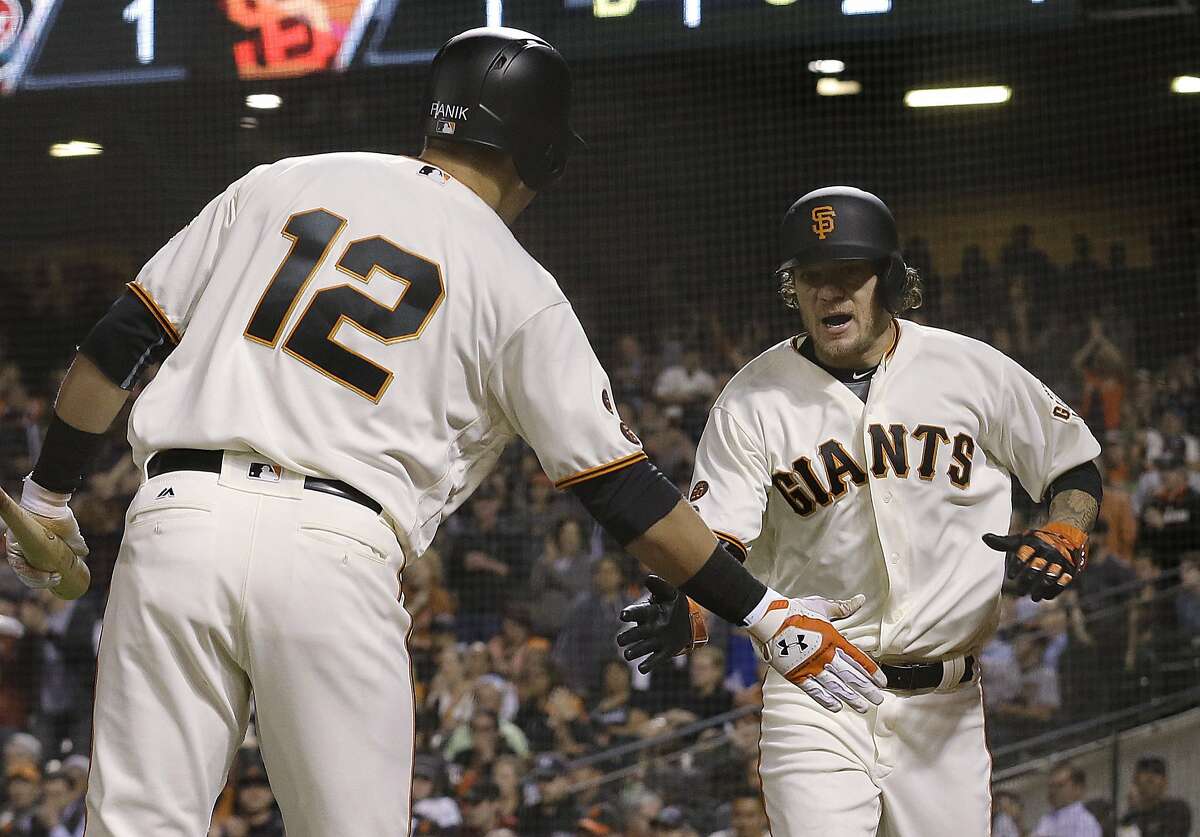 San Francisco Giants' Jake Peavy, right, is congratulated by Joe Panik (12) after scoring against the Arizona Diamondbacks during the second inning of a baseball game in San Francisco, Monday, April 18, 2016.