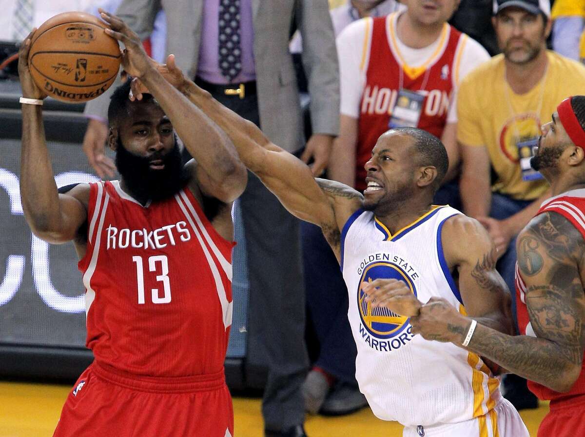 Andre Iguodala (9) defends against James Harden (13) in the first half as the Golden State Warriors played the Houston Rockets in game 2 of the first round of the Western Conference Playoffs at Oracle Arena in Oakland, Calif., on Monday, April 18, 2016.