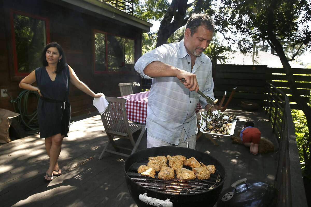 Chef Will Gioia grills chicken with his wife Karen Gioia (left) at home in Mill Valley, California on monday, april 18, 2016.