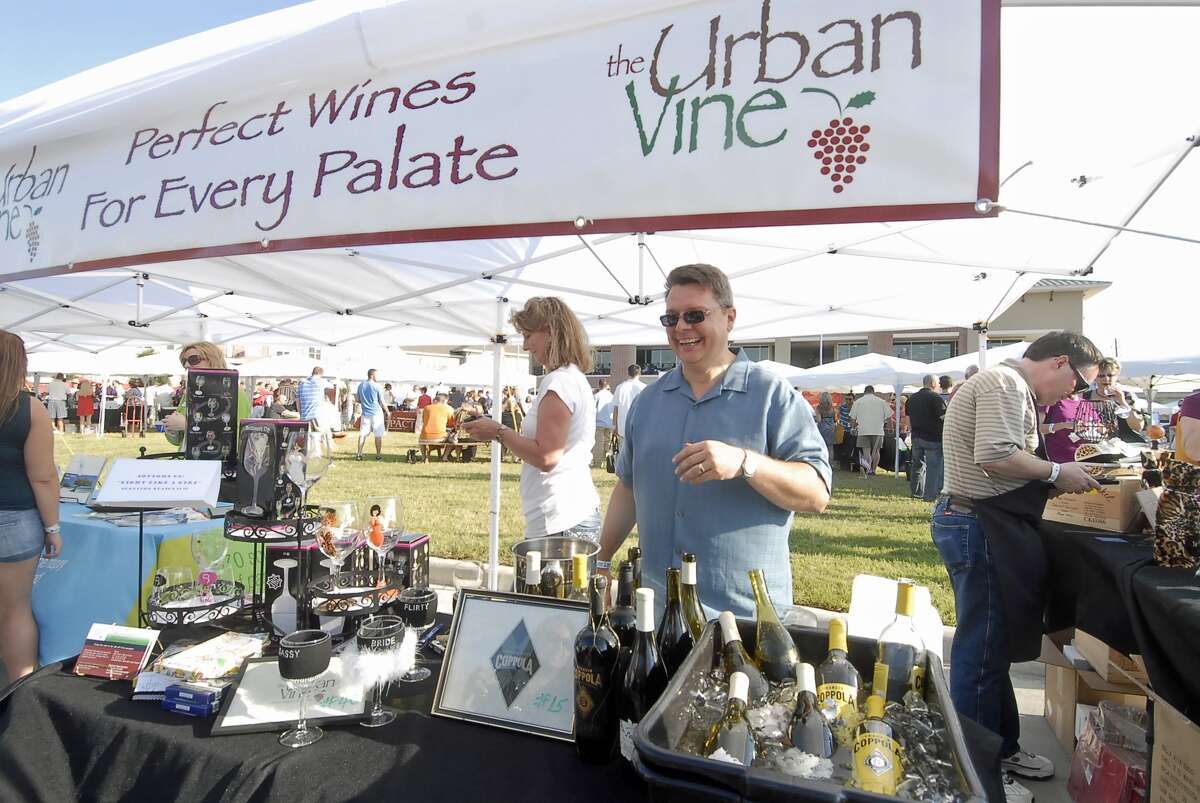 Sara Gordon and Bill Naseman of The Urban Vine serve samples of their products during the first Wine Fair Cy-Fair at Cypress Village Station.