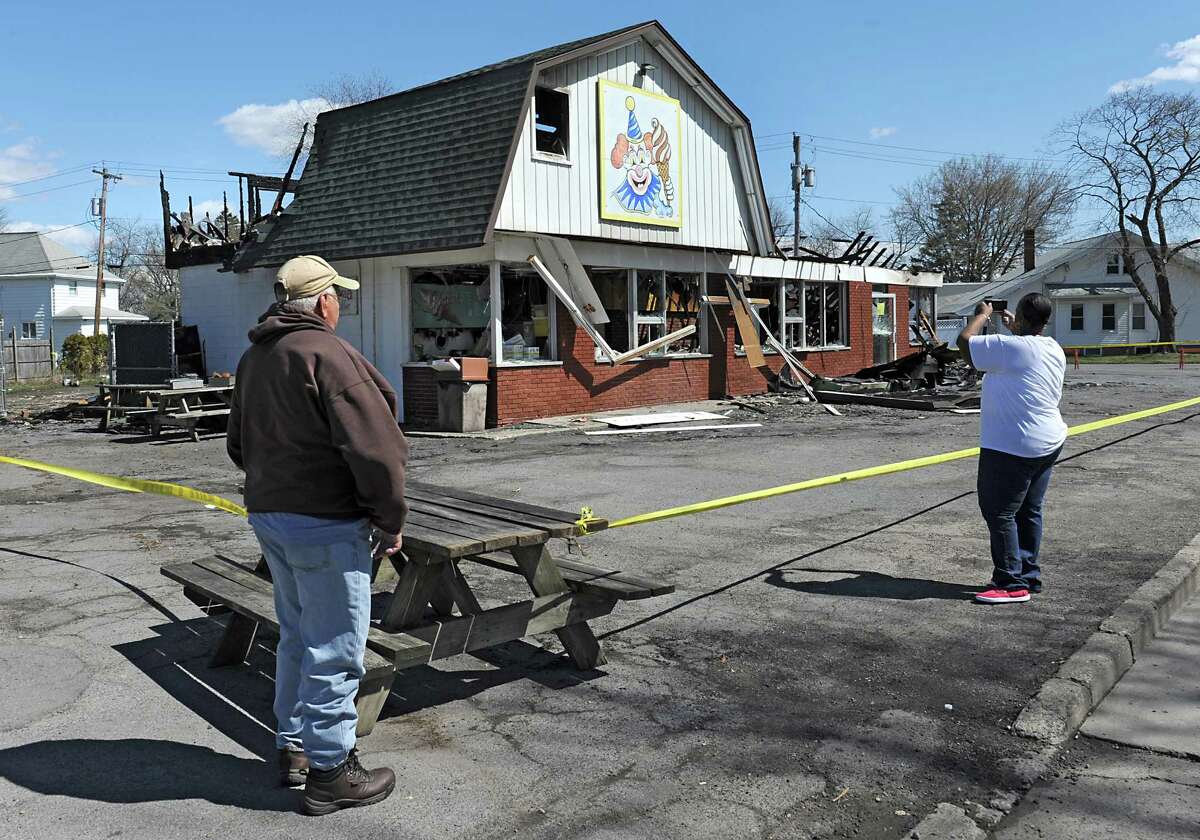 People take photos of Dairy Circus, a Scotia landmark that was destroyed by fire on Monday on Tuesday, April 19, 2016 in Scotia, N.Y. (Lori Van Buren / Times Union)