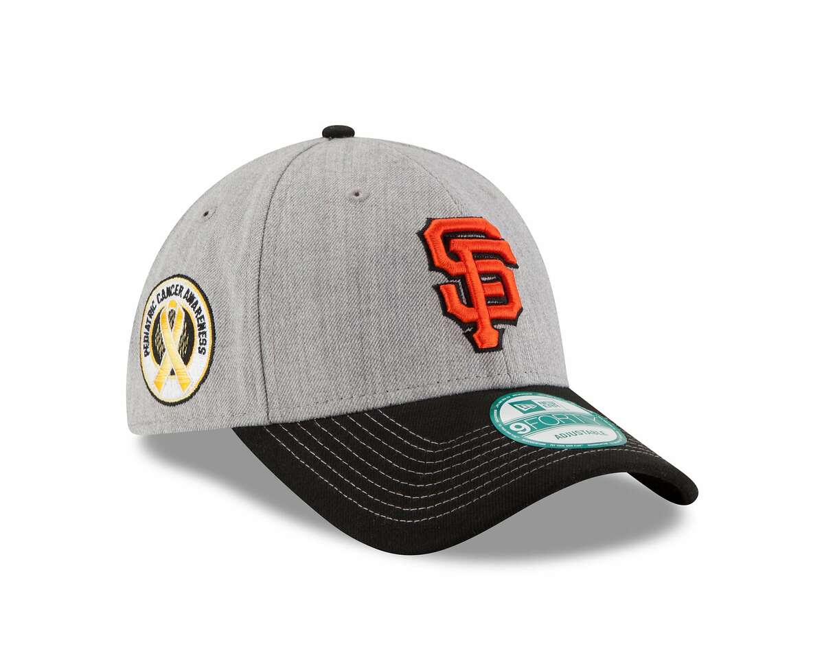 The baseball cap that New Era will unveil on April 20, 2016. It's the Buster Posey Pediatric Cancer Awareness 9FORTY cap, featuring the gold ribbon for Pediatric Cancer Awareness and Giants' logo. Proceeds from sales will go to support pediatric research and treatment.