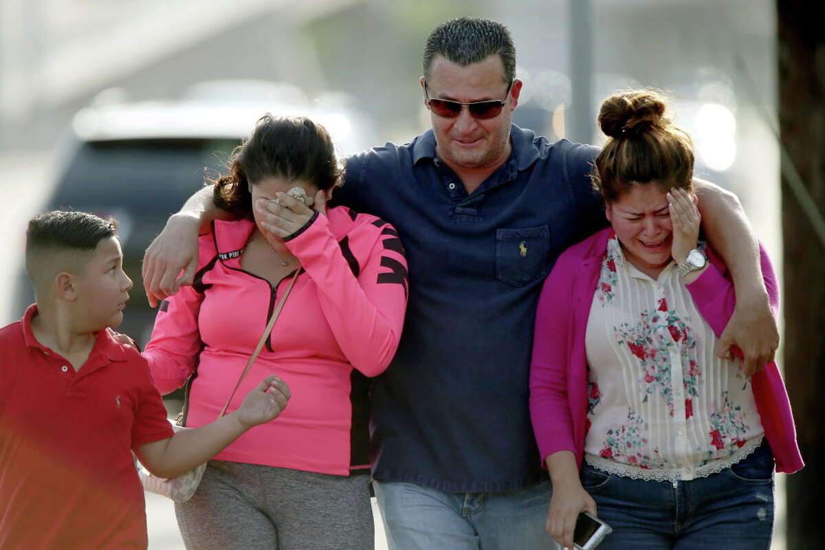 Linda Rodriguez, far right, along with other family members, react after seeing a white SUV, that is believed to belong to a 25-year-old family member, that was towed from the off ramp from the West Park Toll Way onto Post Oak Blvd. Tuesday, April 19, 2016, in Houston. The SUV was submerged in flood water caused by the recent storm. Tuesday, April 19, 2016, in Houston, Texas.