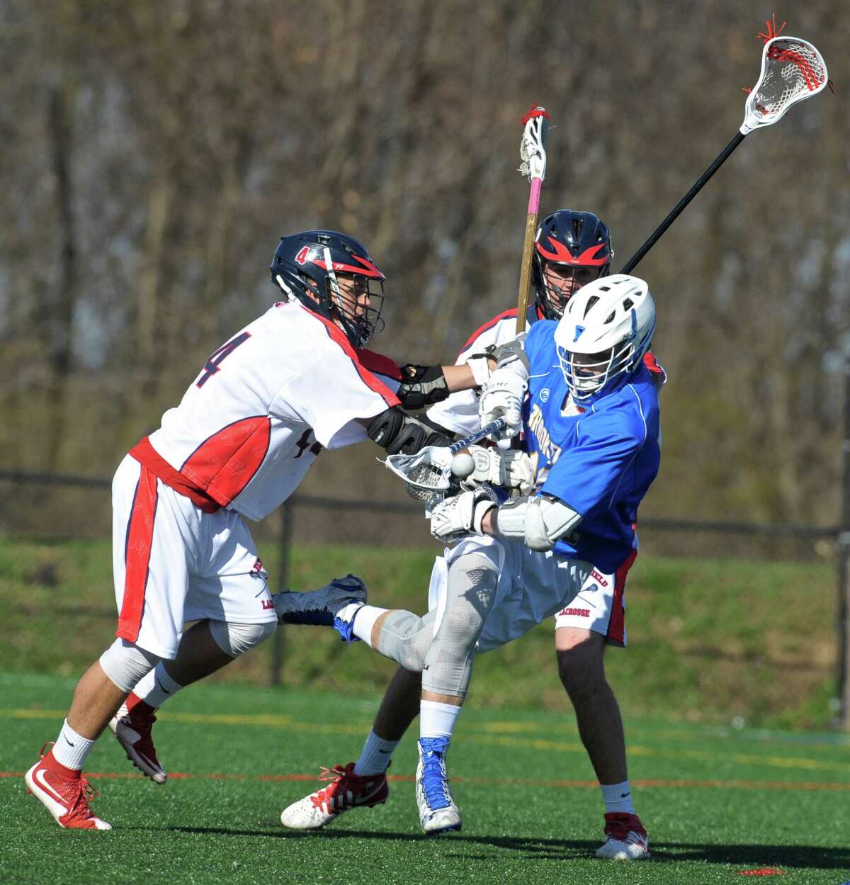 New Fairfield's Zach Buffington (44) knocks the ball loose from Brookfield's Harrison Manesis (10) in the boys lacrosse game between Brookfield and New Fairfield high schools, on Tuesday afternoon, April 19, 2016, at New Fairfield High School, in New Fairfield, Conn. New Fairfield's Fred Zering (35) is behind the play.