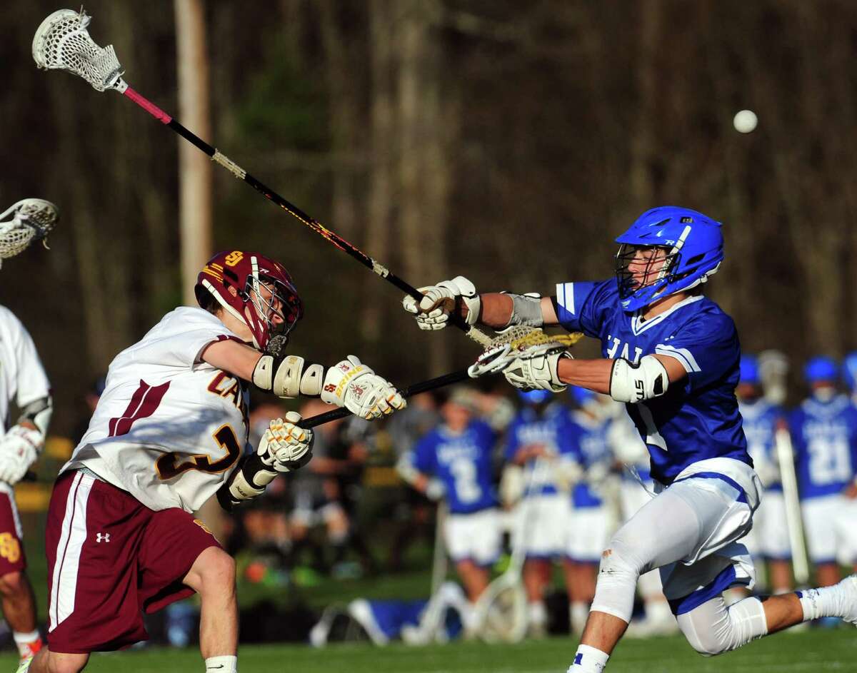 St. Joseph's Nick Celentano, left, attempts a goal shot as Hall's Jordan Weinstock defends during boys lacrosse action in Trumbull, Conn., on Tuesday Apr. 19, 2016.