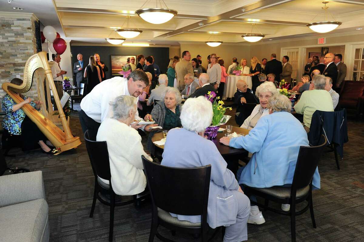Residents come together in the community room in the clubhouse at Glenmont Abbey Village. (Lori Van Buren / Times Union)